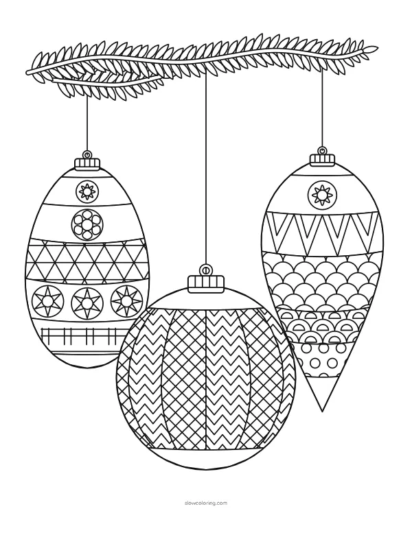 Three patterned ornaments hanging from a pine branch